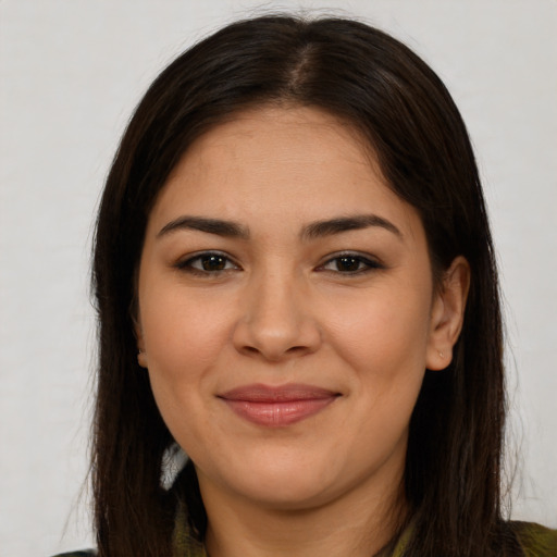 Joyful white young-adult female with long  brown hair and brown eyes