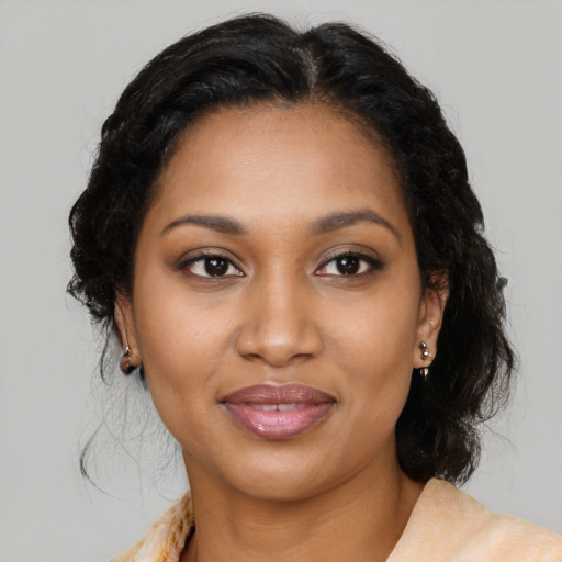 Joyful black young-adult female with medium  black hair and brown eyes