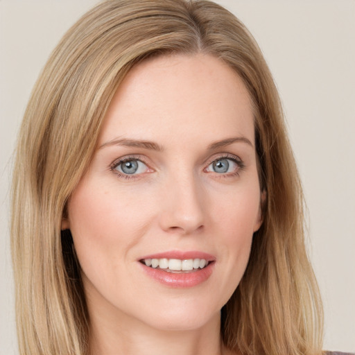 Joyful white young-adult female with long  brown hair and green eyes