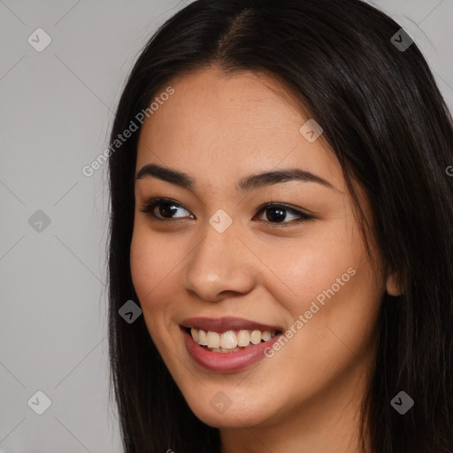 Joyful latino young-adult female with long  brown hair and brown eyes