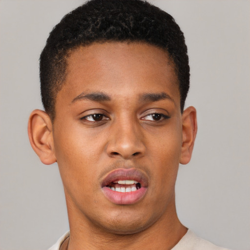 Joyful latino young-adult male with short  brown hair and brown eyes