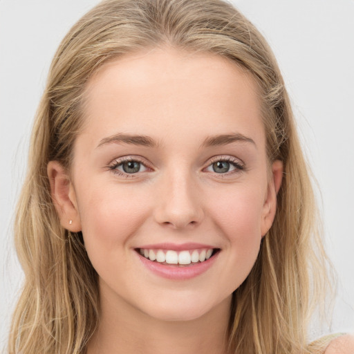 Joyful white young-adult female with long  brown hair and blue eyes