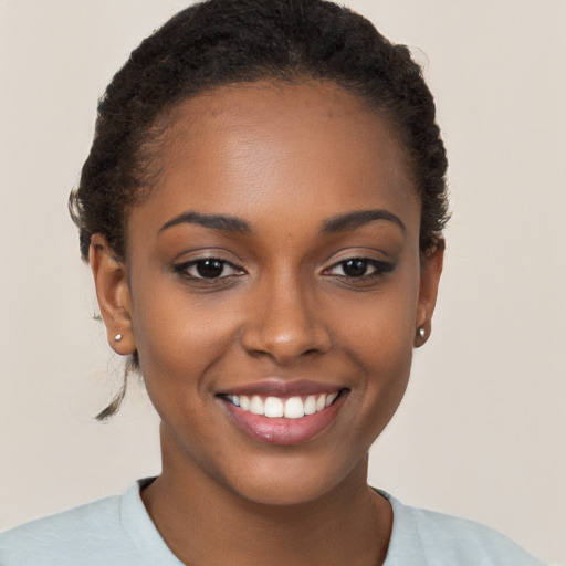 Joyful black young-adult female with short  brown hair and brown eyes