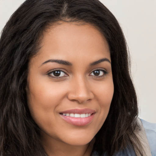 Joyful latino young-adult female with long  brown hair and brown eyes