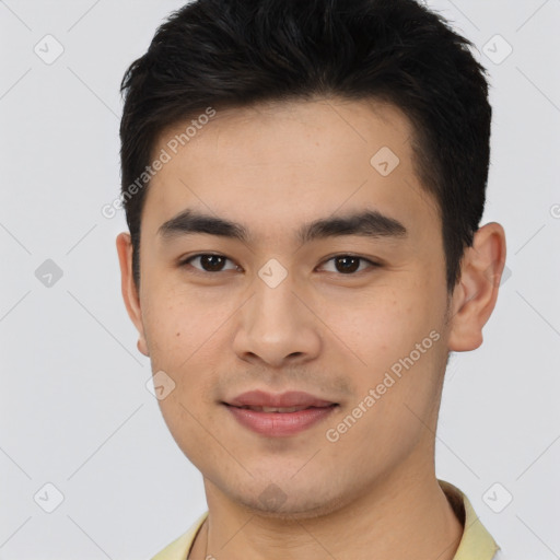 Joyful asian young-adult male with short  brown hair and brown eyes