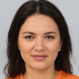 Joyful white young-adult female with medium  brown hair and brown eyes