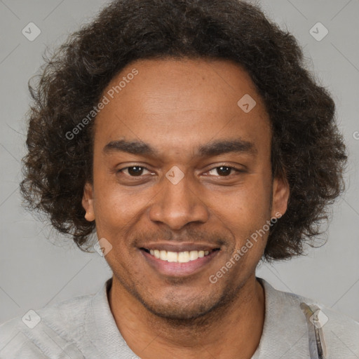 Joyful black young-adult male with short  brown hair and brown eyes