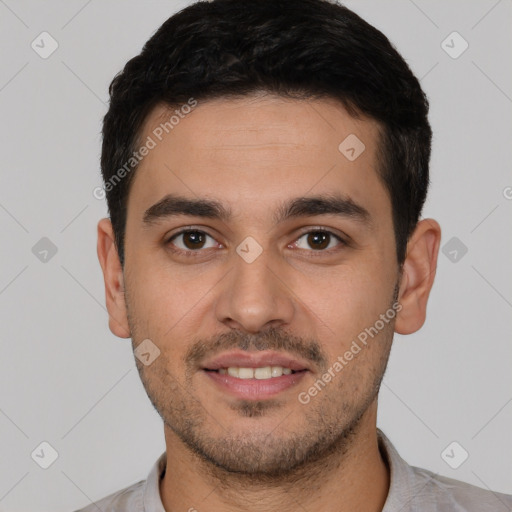 Joyful white young-adult male with short  black hair and brown eyes