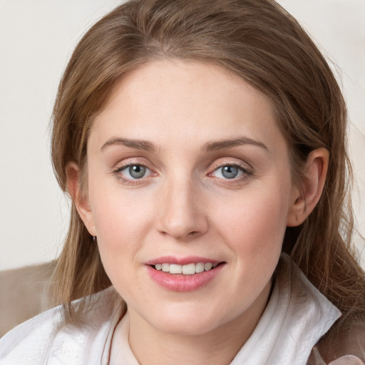 Joyful white young-adult female with medium  brown hair and blue eyes