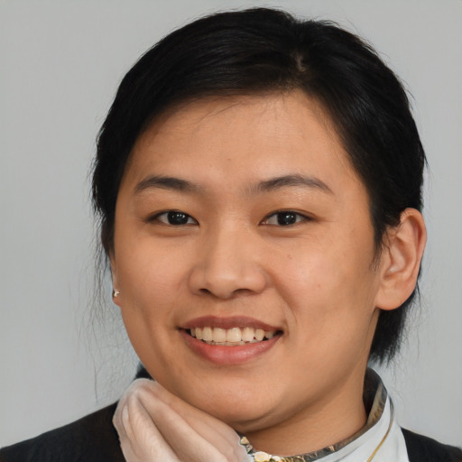 Joyful asian young-adult female with medium  brown hair and brown eyes