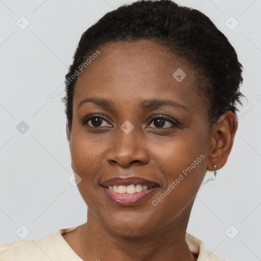 Joyful black young-adult female with short  black hair and brown eyes