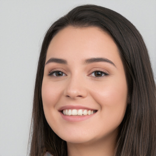 Joyful white young-adult female with long  black hair and brown eyes