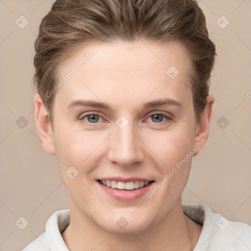 Joyful white young-adult female with short  brown hair and grey eyes