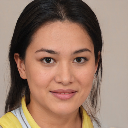 Joyful latino young-adult female with medium  brown hair and brown eyes