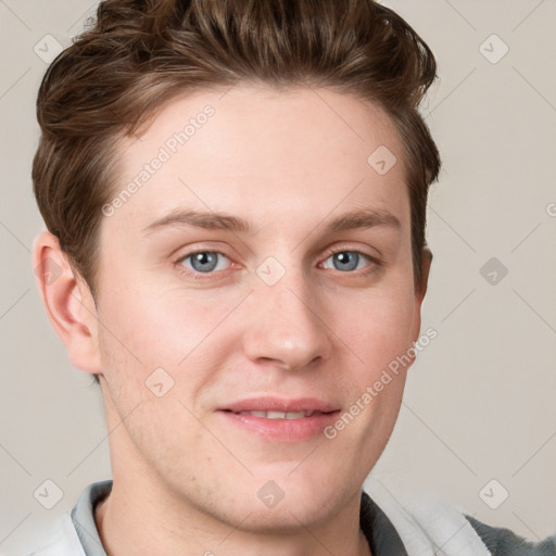 Joyful white young-adult male with short  brown hair and blue eyes