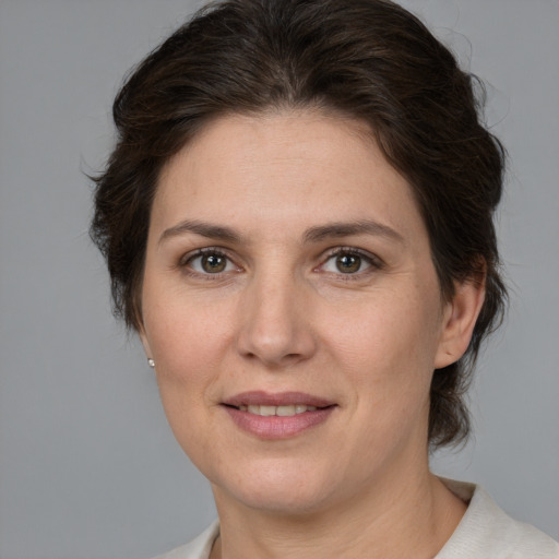 Joyful white adult female with medium  brown hair and brown eyes