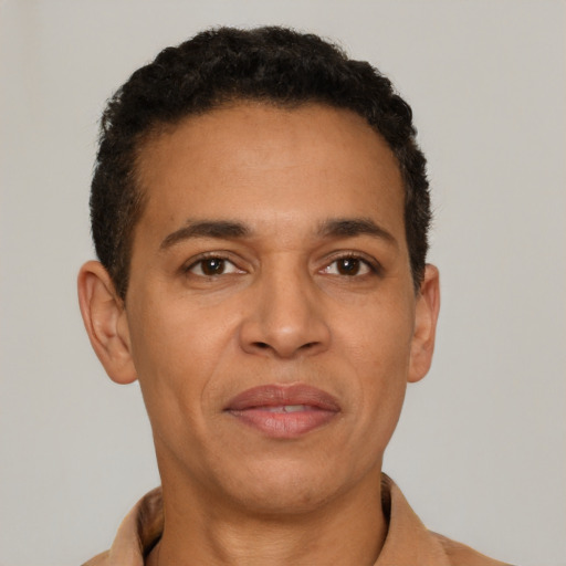 Joyful latino young-adult male with short  brown hair and brown eyes