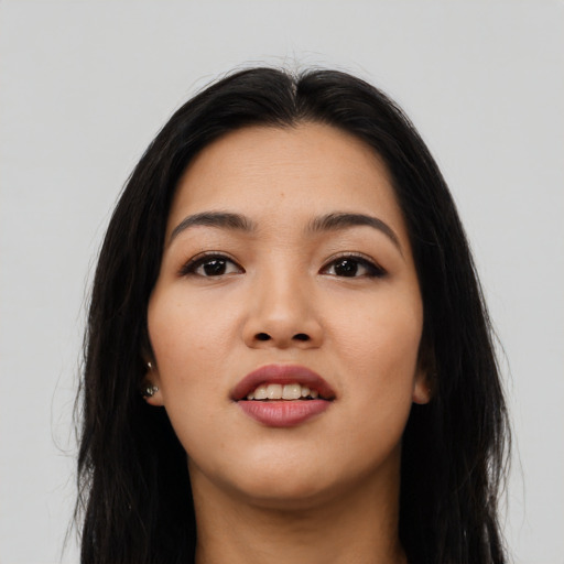 Joyful asian young-adult female with long  black hair and brown eyes
