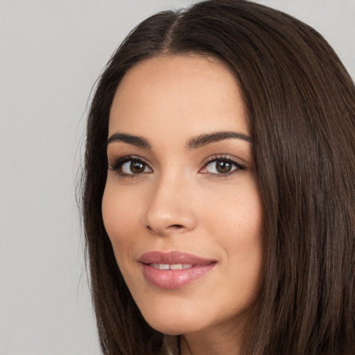 Joyful white young-adult female with long  black hair and brown eyes