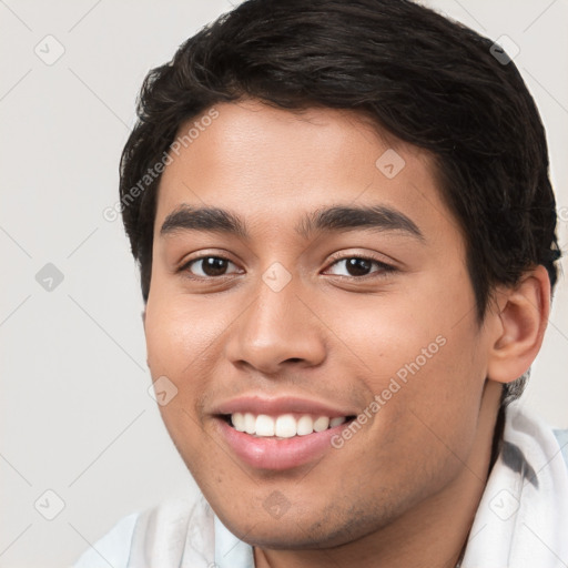 Joyful white young-adult male with short  brown hair and brown eyes