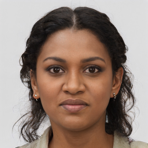 Joyful black young-adult female with long  brown hair and brown eyes