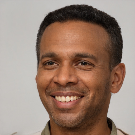 Joyful latino adult male with short  brown hair and brown eyes