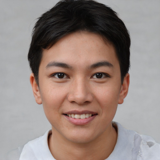 Joyful asian young-adult female with short  brown hair and brown eyes