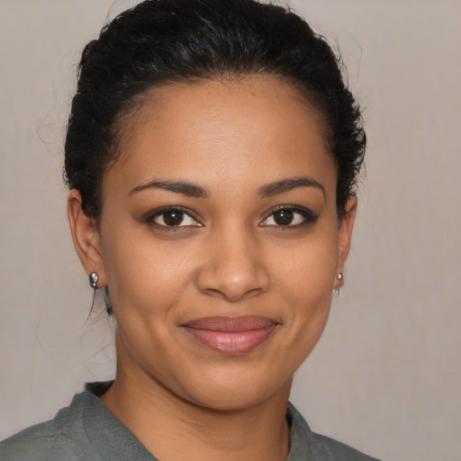 Joyful latino young-adult female with medium  brown hair and brown eyes