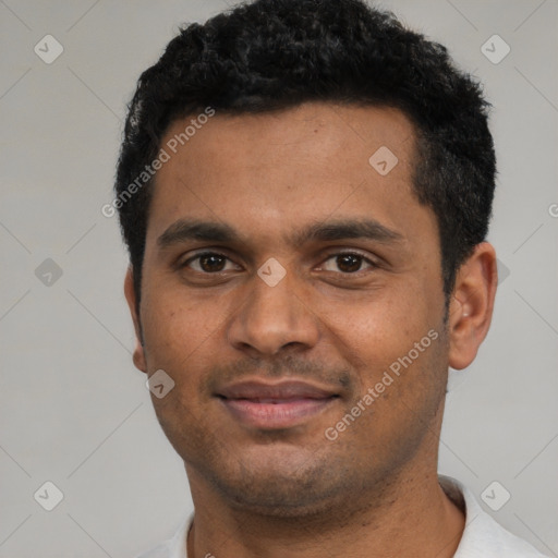 Joyful black young-adult male with short  black hair and brown eyes