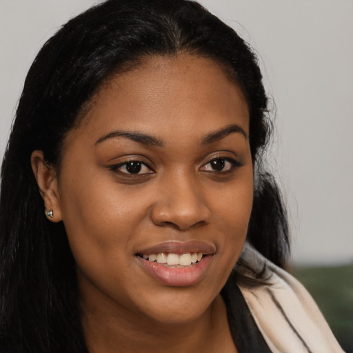 Joyful latino young-adult female with long  brown hair and brown eyes