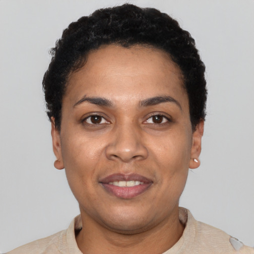 Joyful latino young-adult female with short  black hair and brown eyes
