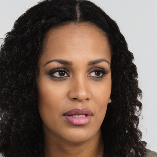 Neutral black young-adult female with long  brown hair and brown eyes