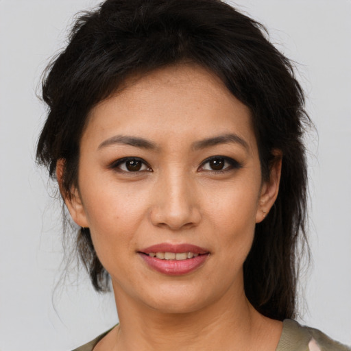 Joyful latino young-adult female with medium  brown hair and brown eyes