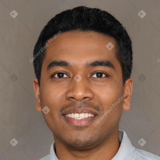 Joyful black young-adult male with short  black hair and brown eyes