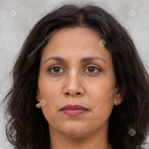 Joyful white adult female with long  brown hair and brown eyes