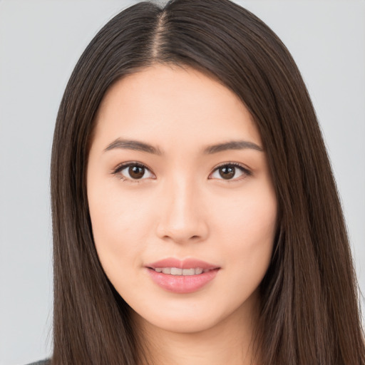 Joyful asian young-adult female with long  brown hair and brown eyes