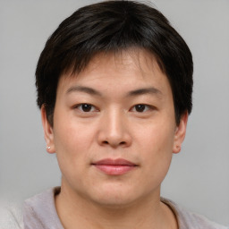 Joyful asian young-adult male with short  brown hair and brown eyes