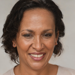 Joyful black adult female with medium  brown hair and brown eyes