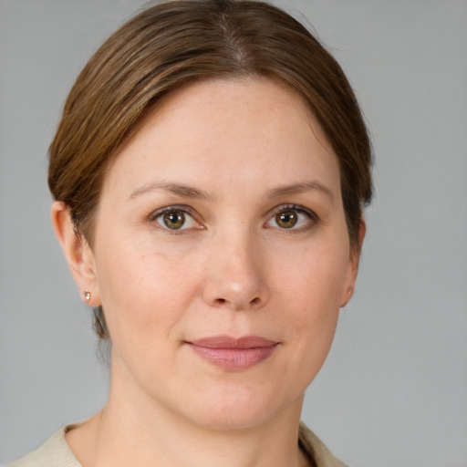 Joyful white young-adult female with short  brown hair and grey eyes