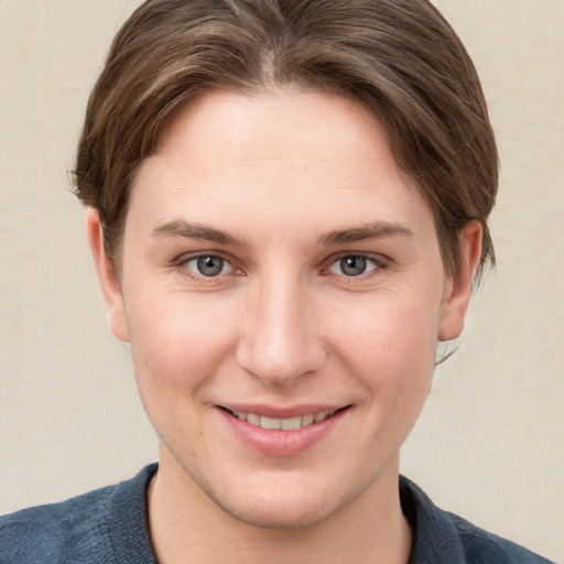 Joyful white young-adult female with short  brown hair and grey eyes