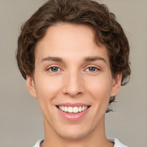 Joyful white young-adult female with short  brown hair and green eyes