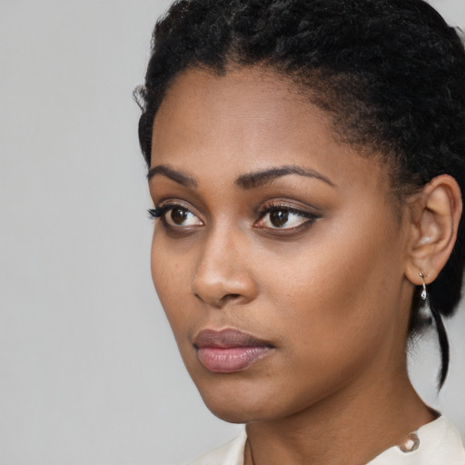 Neutral black young-adult female with short  black hair and brown eyes