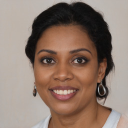 Joyful black young-adult female with medium  brown hair and brown eyes