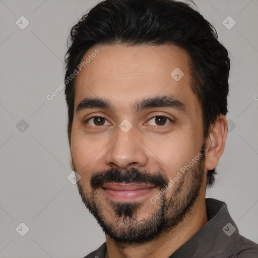 Joyful white young-adult male with short  black hair and brown eyes