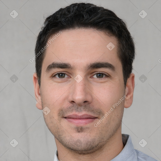 Joyful white young-adult male with short  black hair and brown eyes