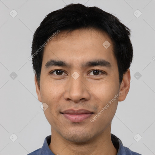 Joyful asian young-adult male with short  black hair and brown eyes