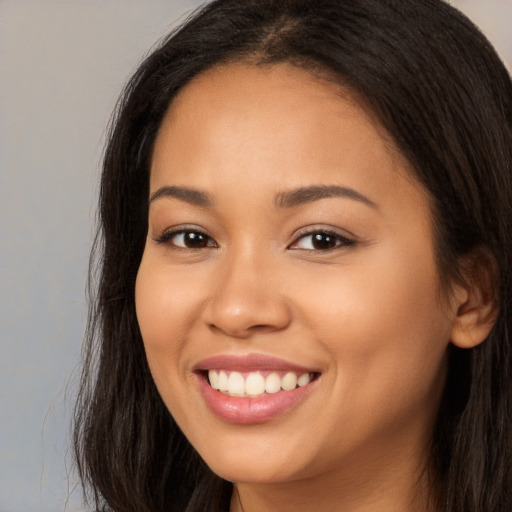 Joyful white young-adult female with long  brown hair and brown eyes