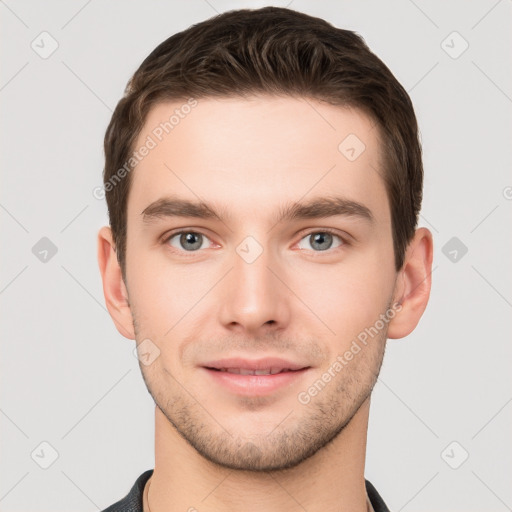 Joyful white young-adult male with short  brown hair and grey eyes