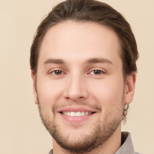 Joyful white young-adult male with short  brown hair and brown eyes