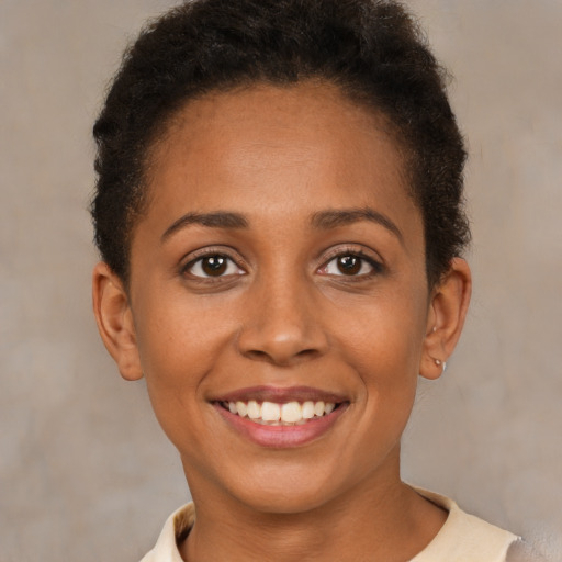 Joyful latino young-adult female with short  brown hair and brown eyes